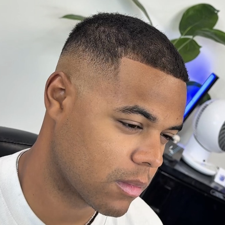 High skin fade haircut with sharp part, side profile